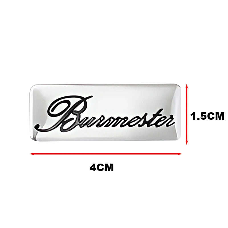 Silver rectangular car audio emblem with the word Bursmester engraved on it