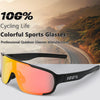 A pair of orange-tinted sports glasses resting on a white surface with a blurred scenic background.