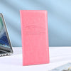 A pink leather vehicle organizer with embossed text for registration and insurance documents.