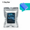 A silver pouch of clay bar product next to a blue rectangular bar.