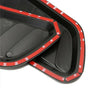Close-up view of a black carbon fiber car hood scoop vent trim with red accents.