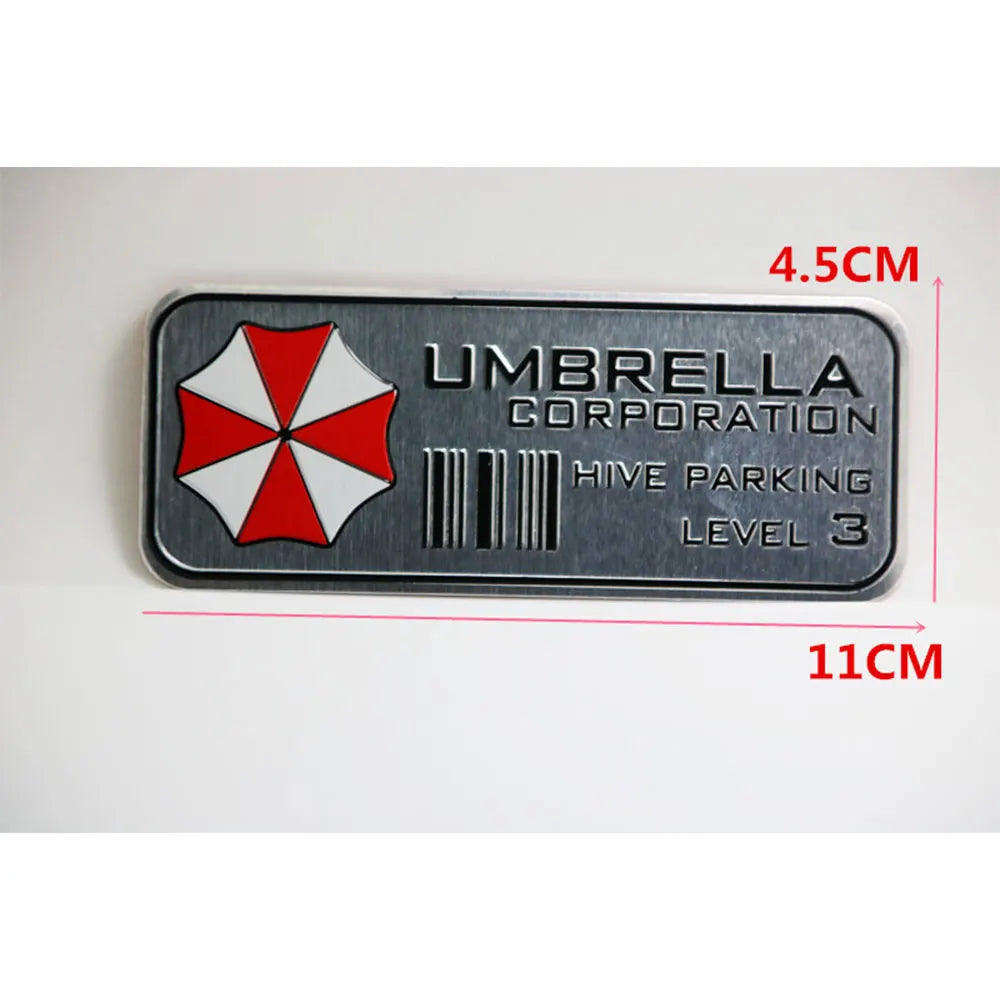 A rectangular silver decal for Hive Parking Level 3 from Umbrella Corporation with a red and white umbrella design