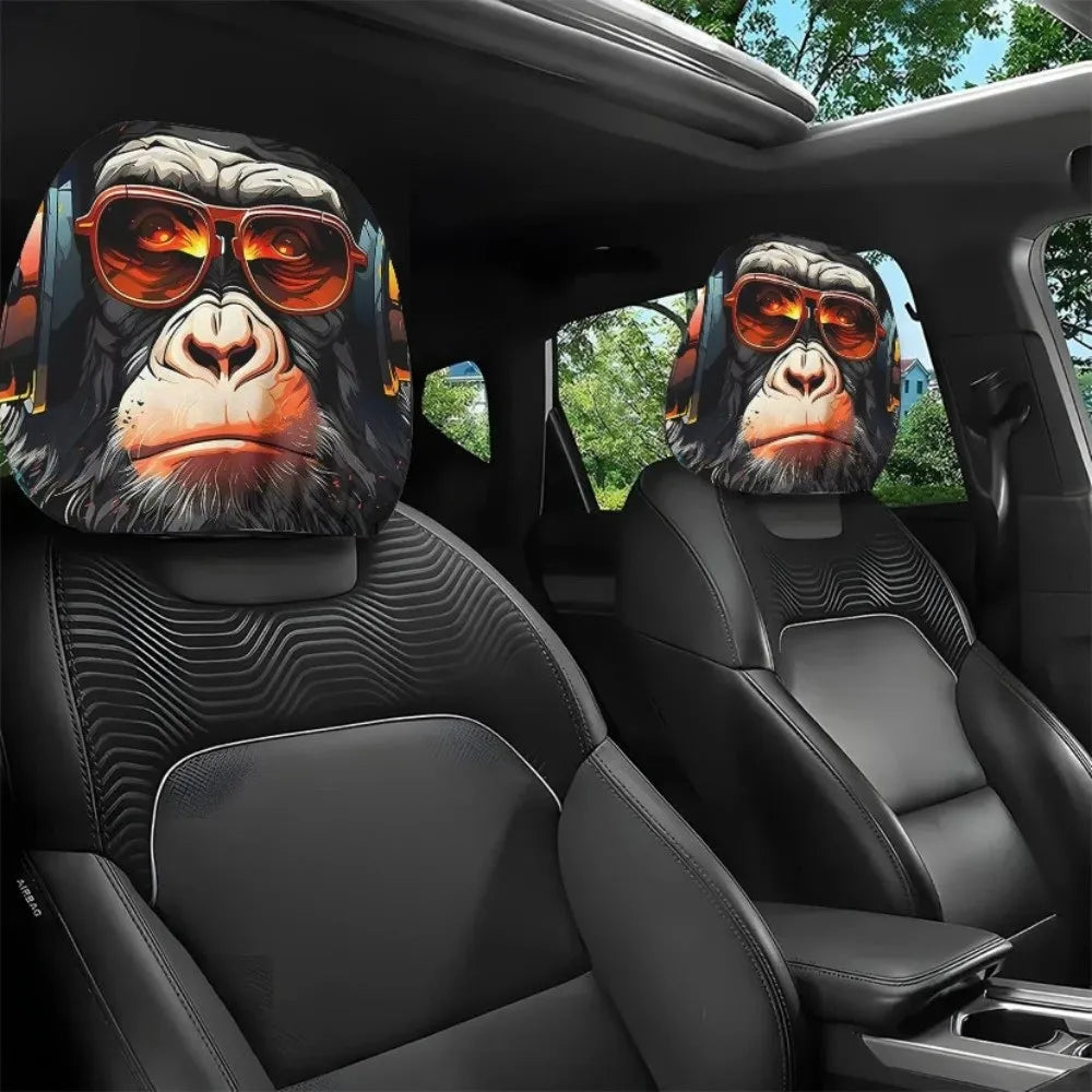 Two black gorilla headrest covers with orange sunglasses are shown in a car interior.