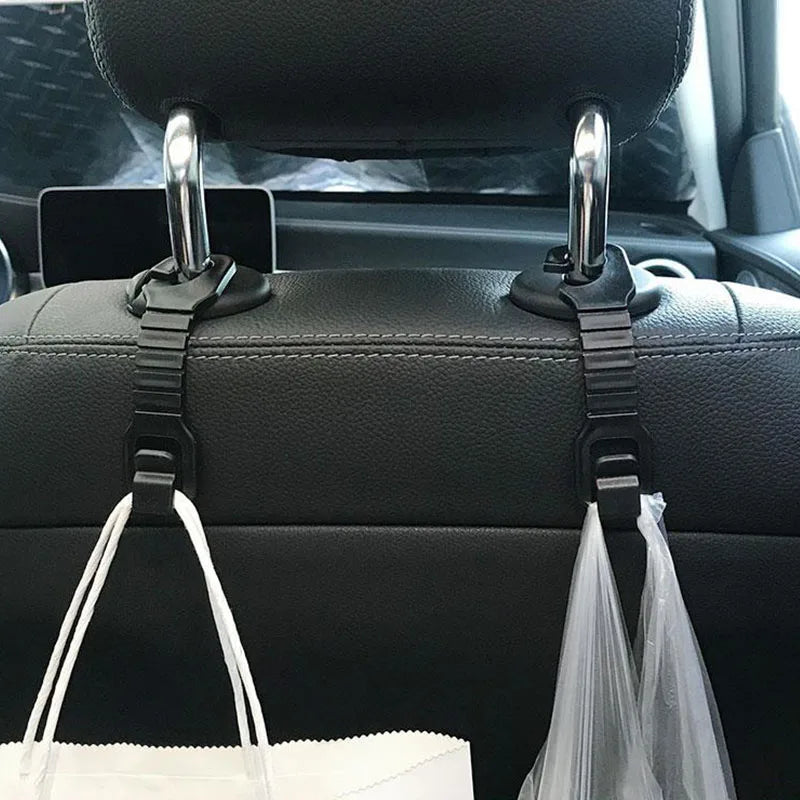 Black storage hooks for car seat back headrests with clear plastic bags hanging from them