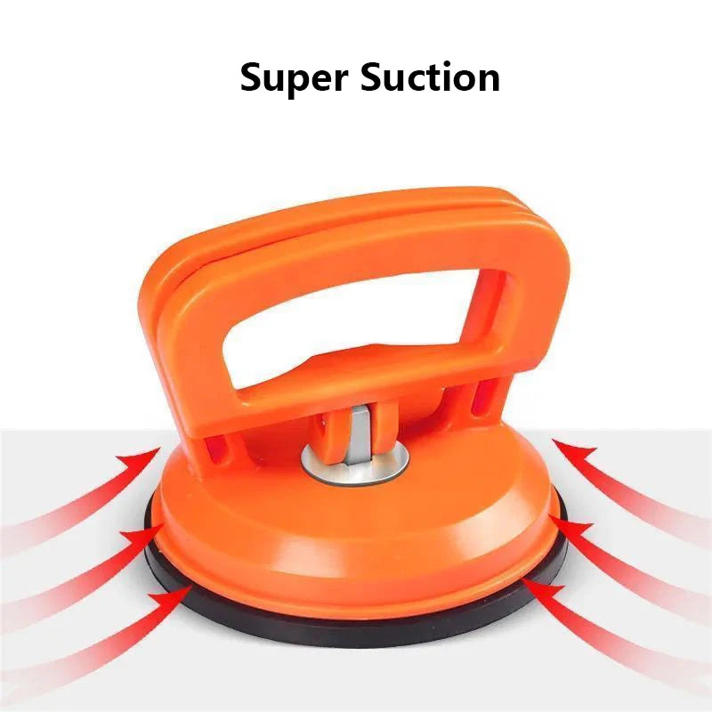 Orange car dent remover puller with a suction cup mechanism shown on a white background.