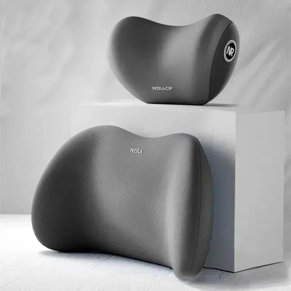 A gray ergonomic memory foam pillow set, including a distinct neck pillow and a larger lumbar support pillow.