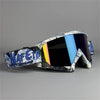 A pair of black and white motorcycle off-road goggles with blue lenses and blue accents.