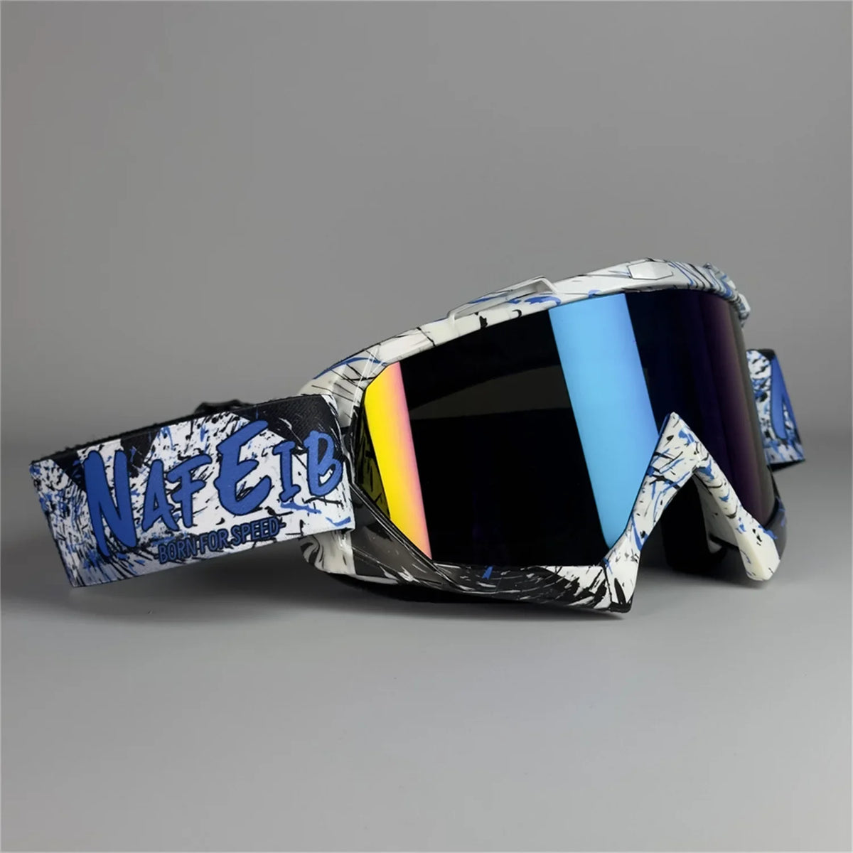 A pair of black and white motorcycle off-road goggles with blue lenses and blue accents.