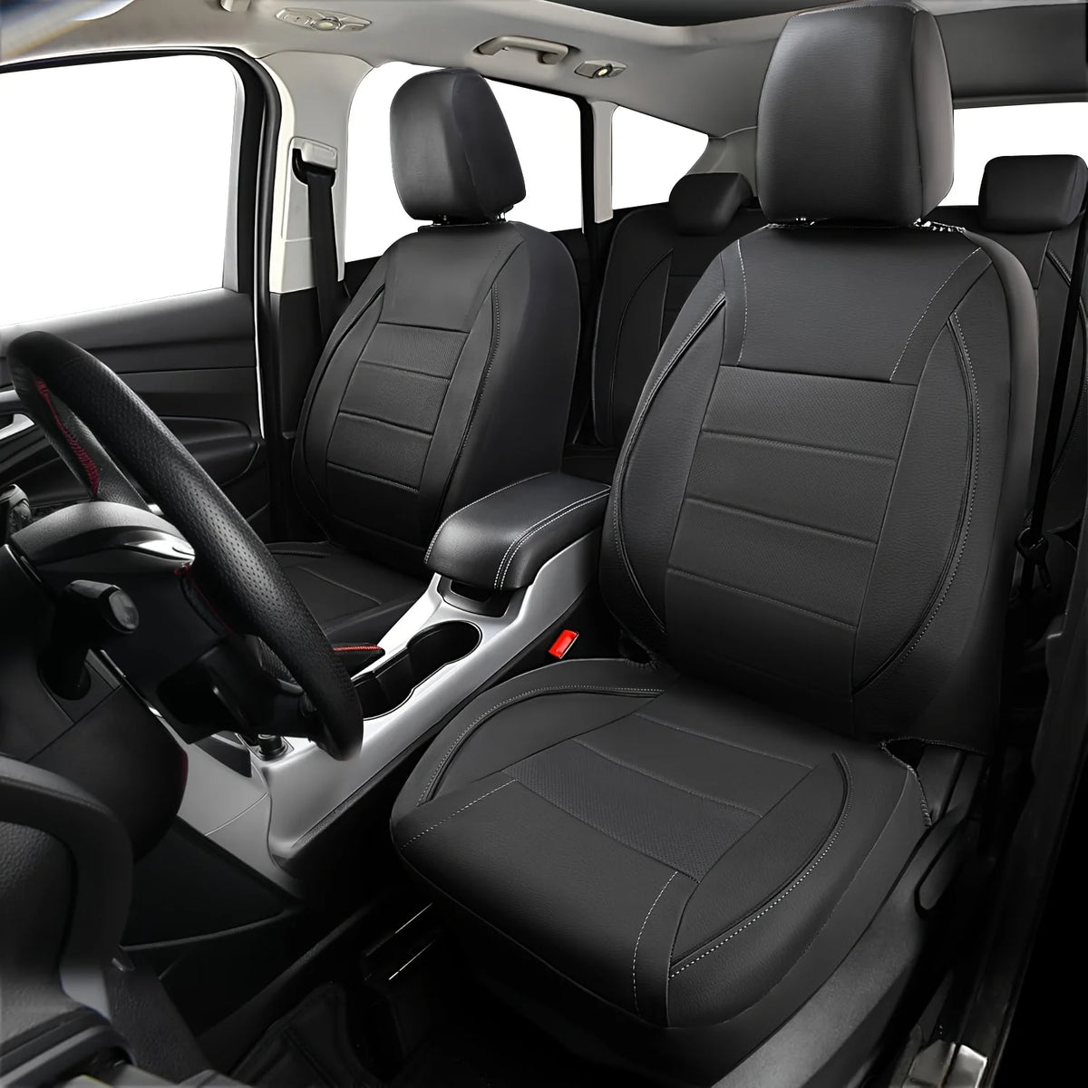Interior view of a car showing black leather seat covers and a steering wheel.
