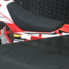 Close-up view of a black universal motorbike seat cover installed on a red and white off-road bike.