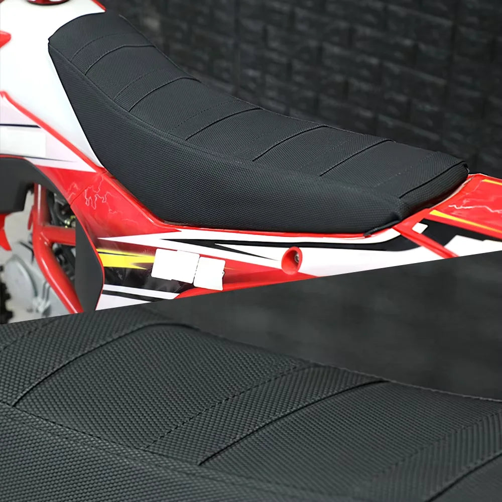 Close-up view of a black universal motorbike seat cover installed on a red and white off-road bike.