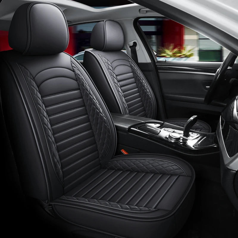 Interior view of a car showing black leather seats and a driver's door panel.
