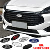 A close-up of a white Ford vehicle's front grille and emblem, with various size Ford badges shown below.