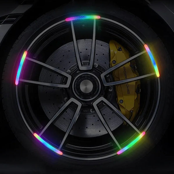 Close-up of a car wheel hub with colorful reflective strips for night driving