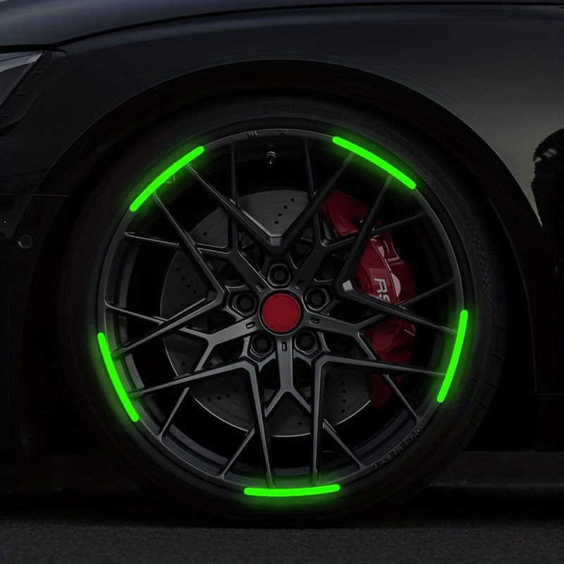 Close-up of a black car wheel with bright green reflective decals and spokes.