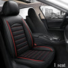 Interior view of a black car seat with red stitching and leather covers, showing the front passenger seat.