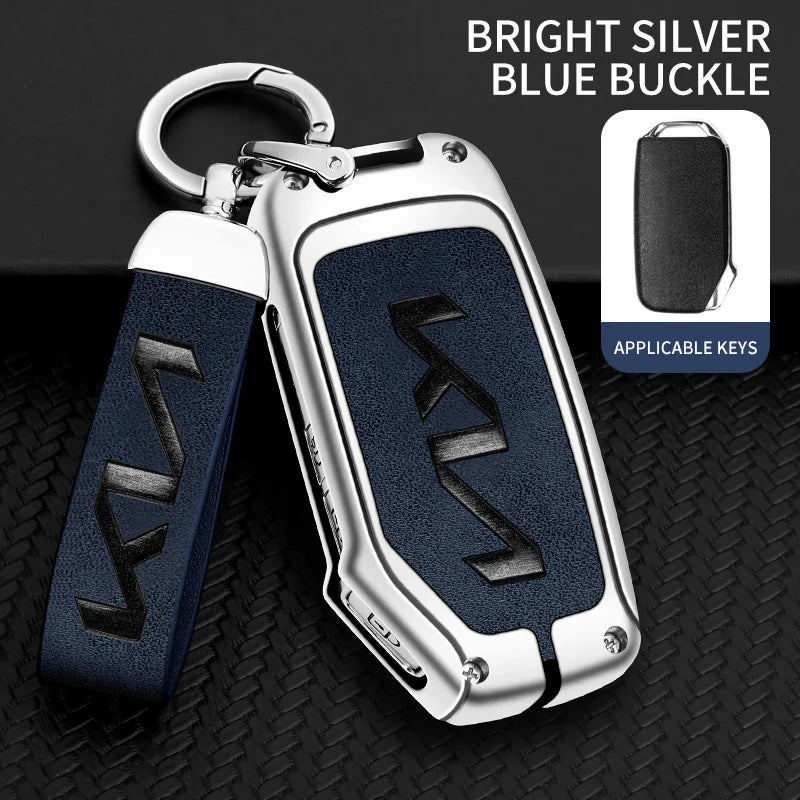 A silver and blue buckle car key case with a leather strap is shown against a black background.