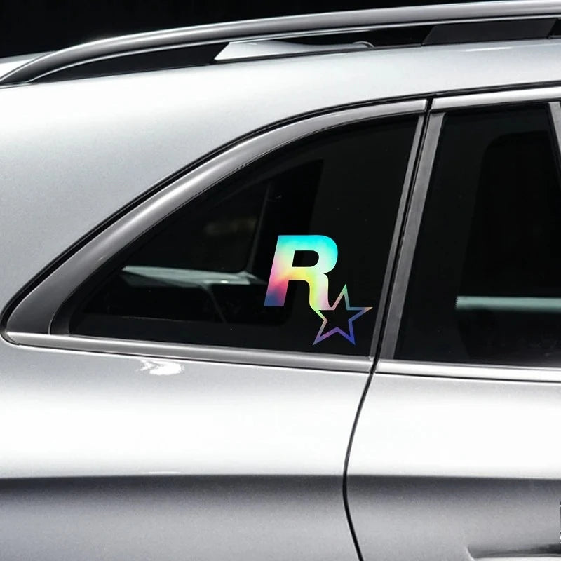 A close-up of a silver car window featuring a colorful reflective star decal.