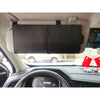 A black leather car sun visor extender is installed in a vehicle interior above the dashboard.