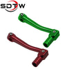 A pair of universal motorcycle gear shift levers, one green and one red, shown against a white background.