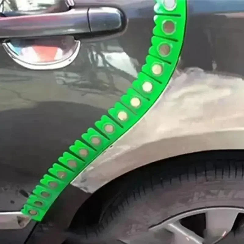 A close-up of a green magnetic strip, used for car sheet metal dry grinding, is attached to the side of a vehicle.