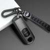 A close-up of a universal car key cover for Mazda models attached to a black keychain.
