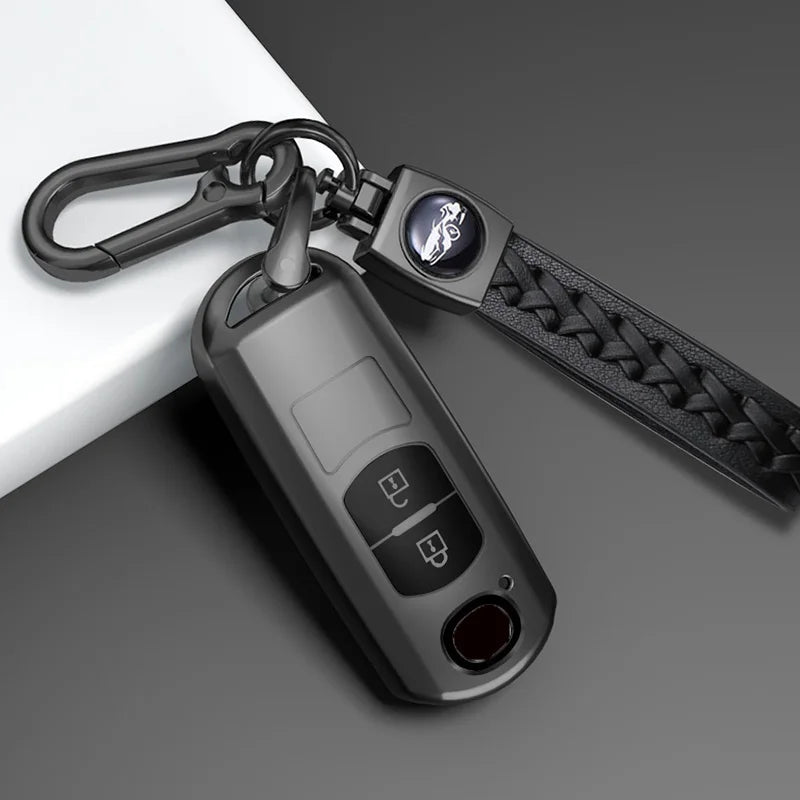A close-up of a universal car key cover for Mazda models attached to a black keychain.