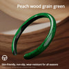 A close-up of a green peach wood grain steering wheel cover shown on a wooden surface.