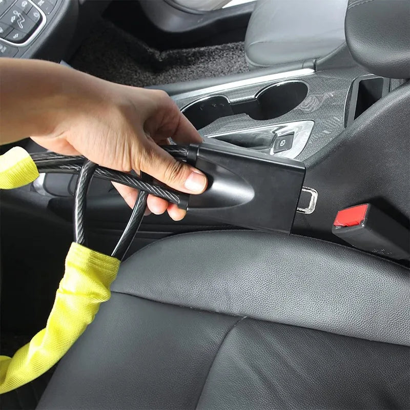 A hand is operating a universal steering wheel and seatbelt lock mechanism inside a car interior.