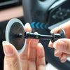 A hand holds a black blind spot mirror with an adjustable knob, demonstrating a car safety product.