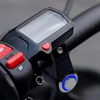 Close-up of a black headlight kill switch device with a clear protective cover and red buttons.
