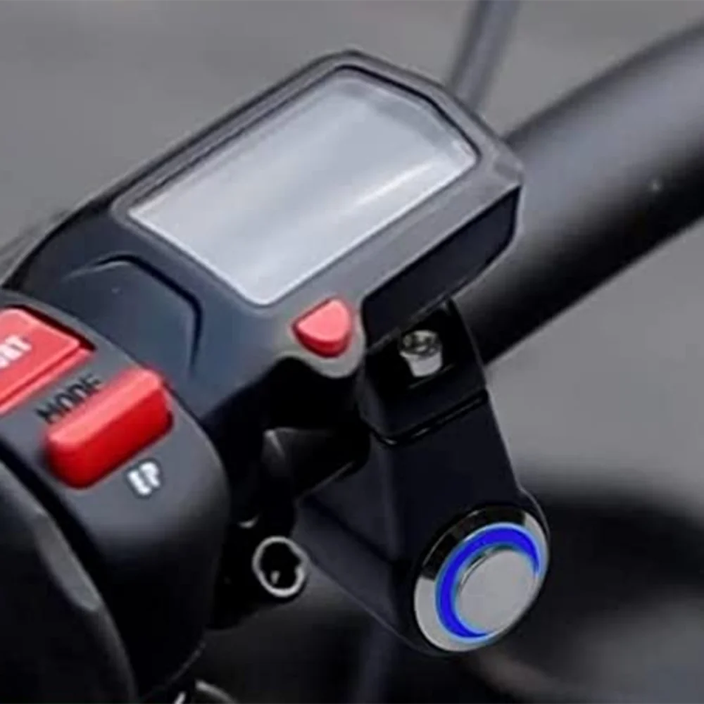 Close-up of a black headlight kill switch device with a clear protective cover and red buttons.