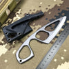A black fixed blade knife is shown next to a silver blade and a ruler on a camouflage background.