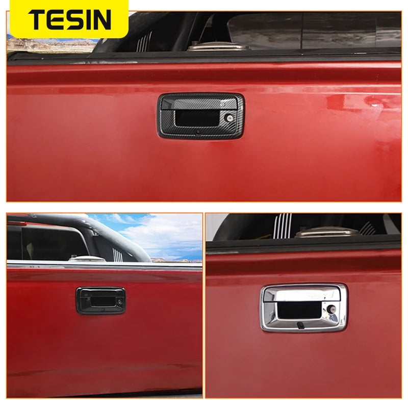 Close-up view of a red vehicle tailgate with two different exterior handle trim covers.