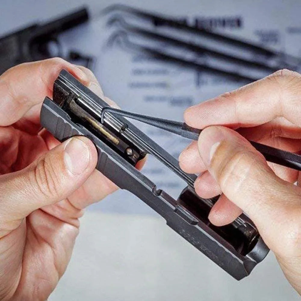 Hands holding a black 7-piece car detailing brush and pick set for cleaning.