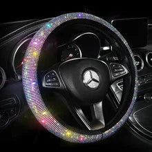 A black steering wheel covered in sparkling, multicolored rhinestones.