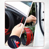 A hand is installing a black rubber door seal strip on a white car door, showing the product's flexible and weather-stripping
