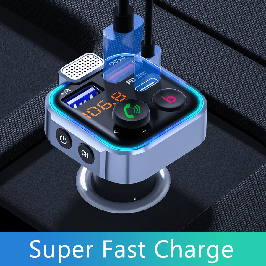 A silver Bluetooth car audio transmitter device showing its charging port and controls on a black surface.