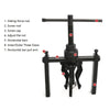 A black three-claw bearing puller tool with various components like a sliding force rod and horizontal bars.