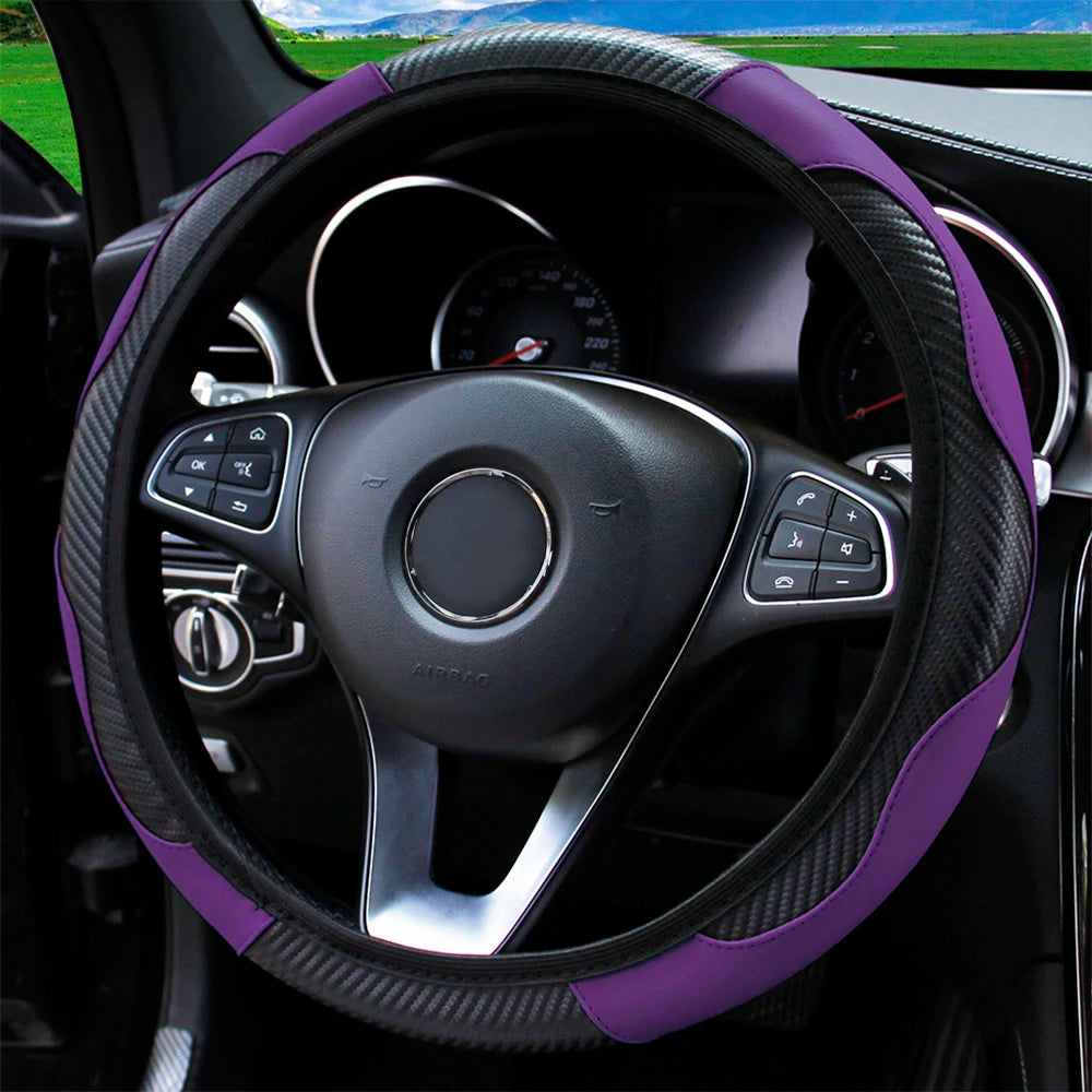 A black steering wheel with a purple PU carbon fiber cover, showing the instrument cluster and controls.