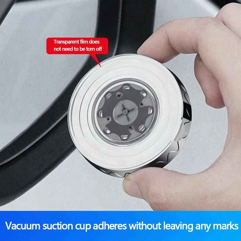 A hand is shown applying a vacuum suction cup to a transparent film on a circular mirror.