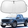 A white UV protection windshield sunshade is shown next to a blue Ford F-150 pickup truck.