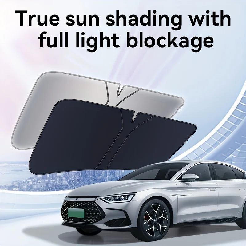 A black heavy-duty portable car sunshade is shown blocking sunlight on a silver sedan.