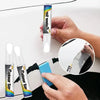 A hand holds a Colour Smart pen for car scratch repair, demonstrating its use with a mirror.
