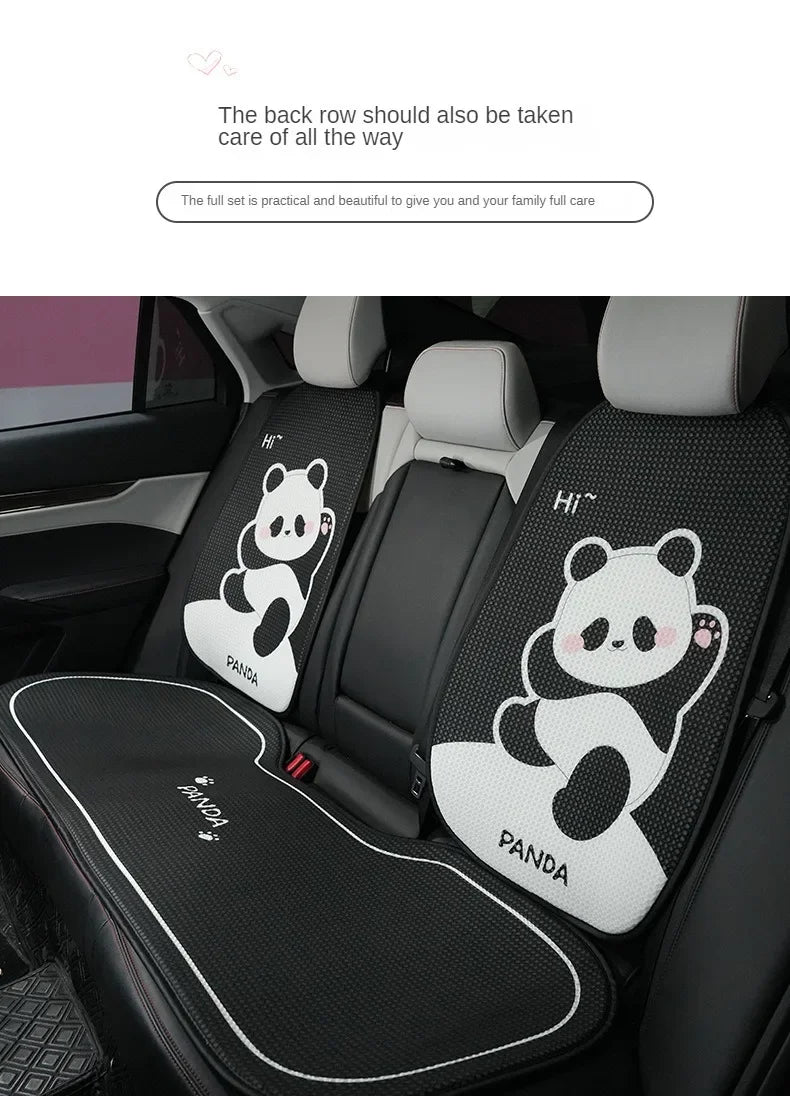A set of black and white cartoon panda car seat cushions installed in a vehicle interior.