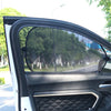 A close-up view of a car side window with a black sunshade installed.