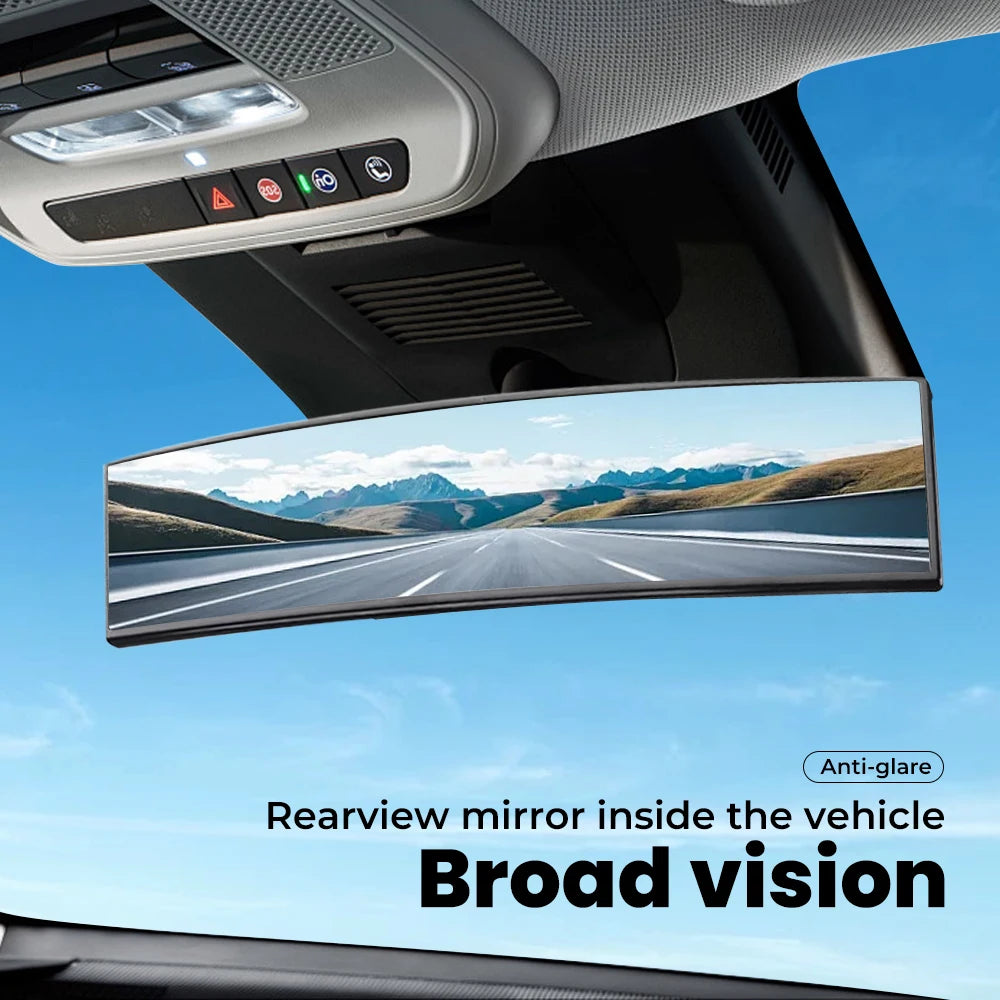 A wide-angle convex rearview mirror inside a vehicle showing a clear view of the road.