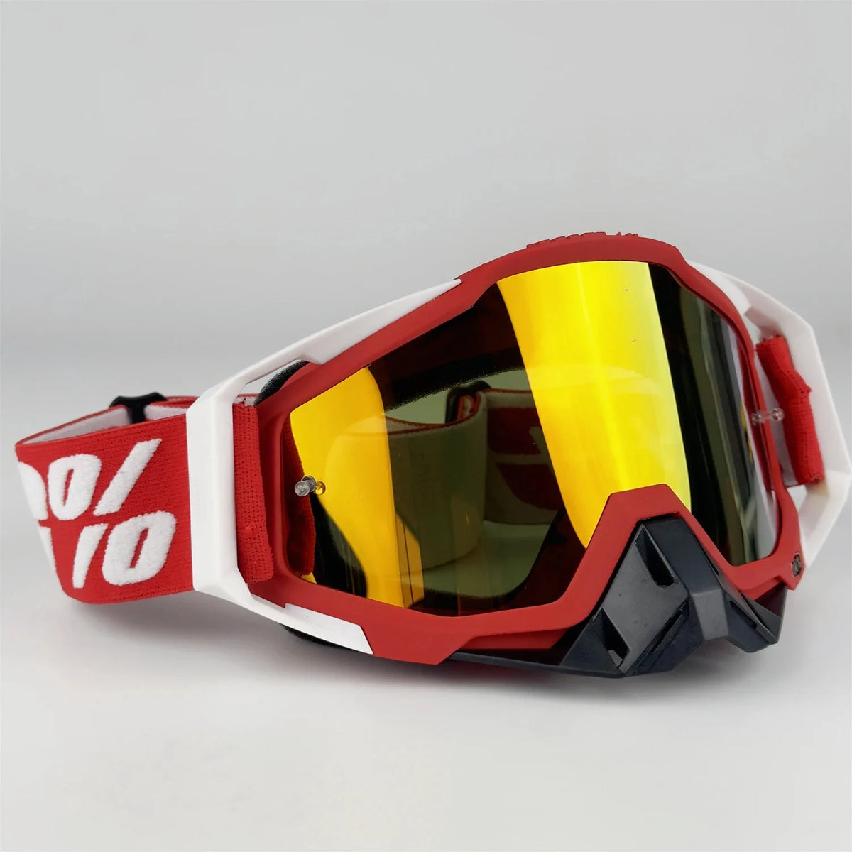 A pair of red and white off-road motorcycle riding goggles with yellow tinted lenses.