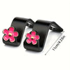 Supports pour la tête des sièges auto noirs avec accents de fleurs roses pour l'organisation