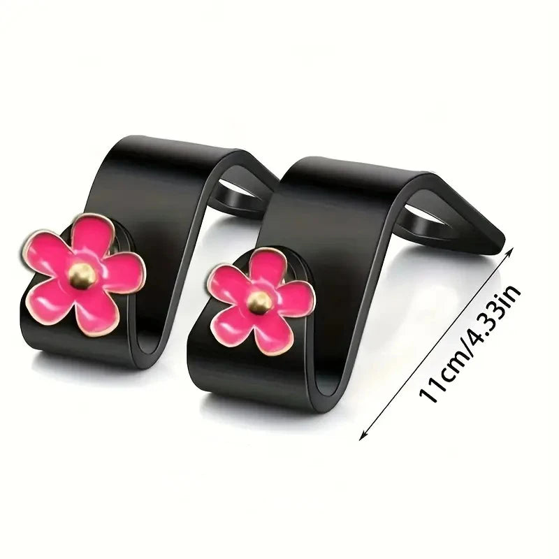Supports pour la tête des sièges auto noirs avec accents de fleurs roses pour l'organisation